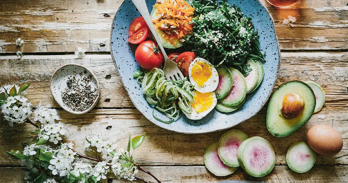 A plate of veggies and eggs on table