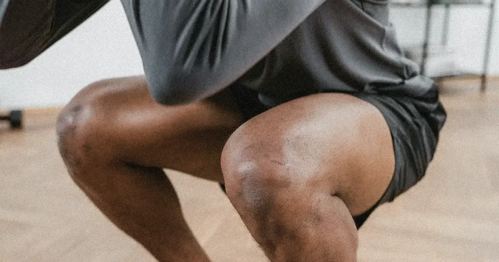 A man doing bodyweight squat exercise