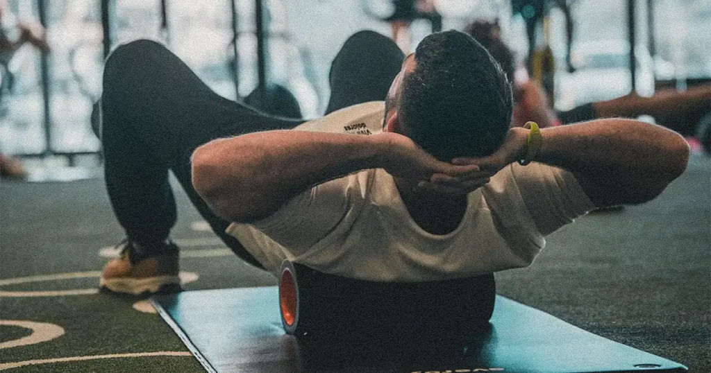 man doing foam rolling