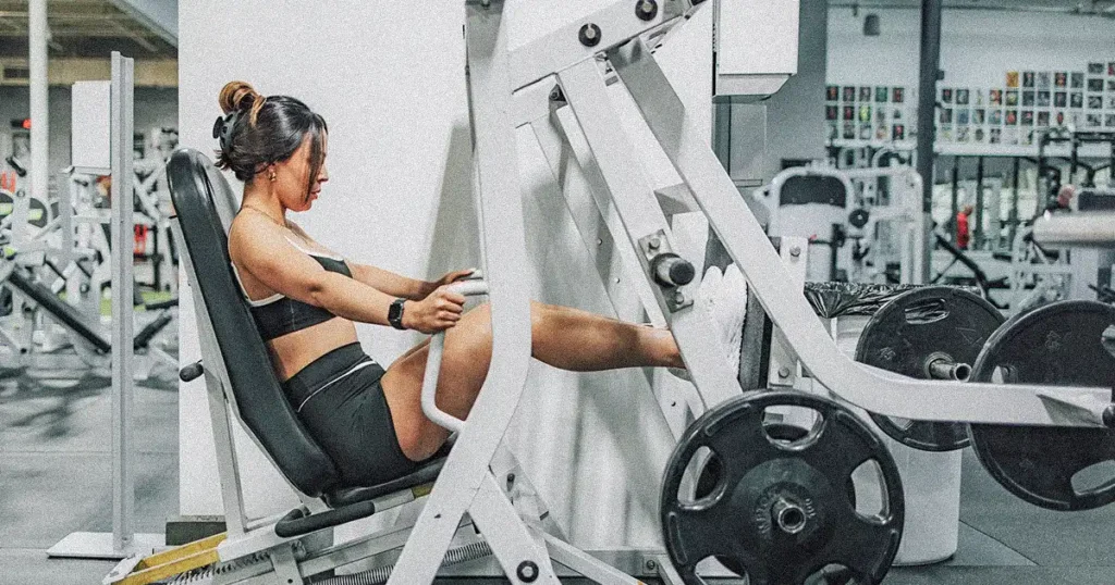 girl on leg press machine