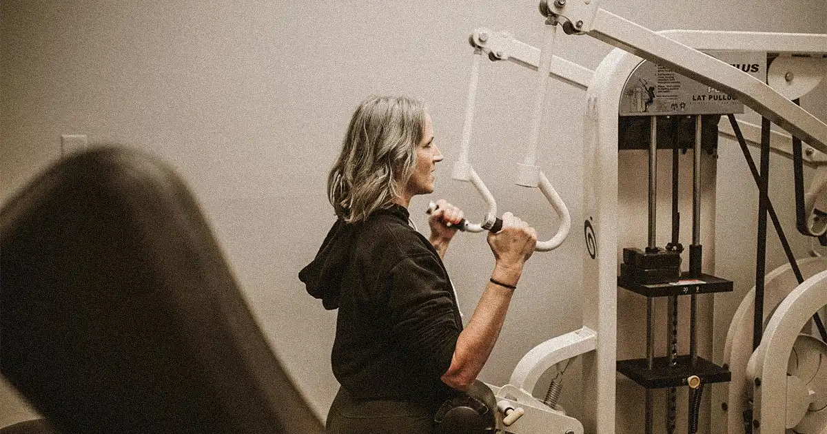 Senior doing lat pulldown machine