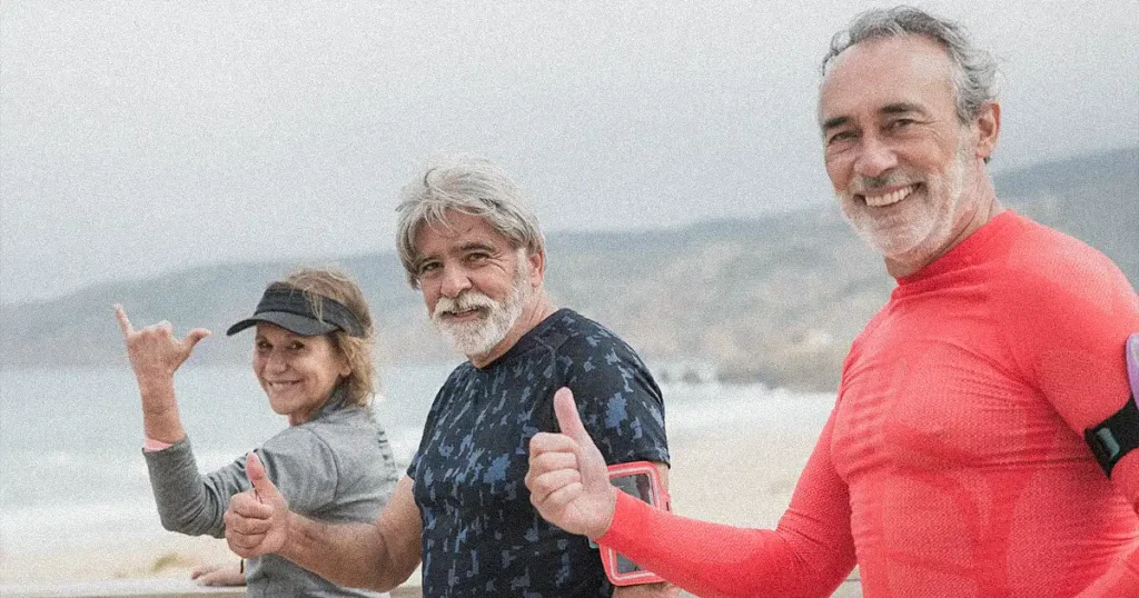 Two men and a lady taking a photo after exercising