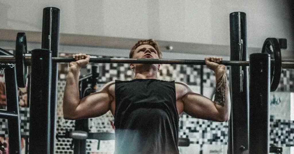 A man doing standing military press