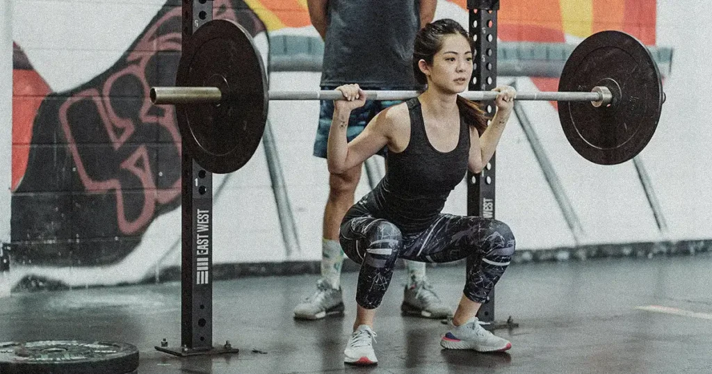 A woman doing barbell squat